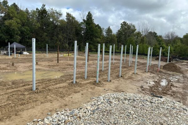 The construction site of the future Kincardine Staybridge hotel, dirt with foundational posts inserted.